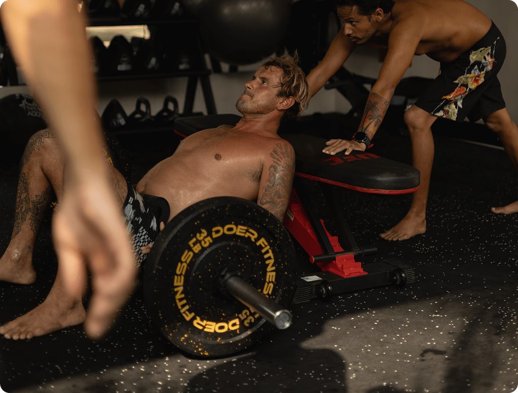 Men training together with weights during the KORU Retreat in Costa Rica